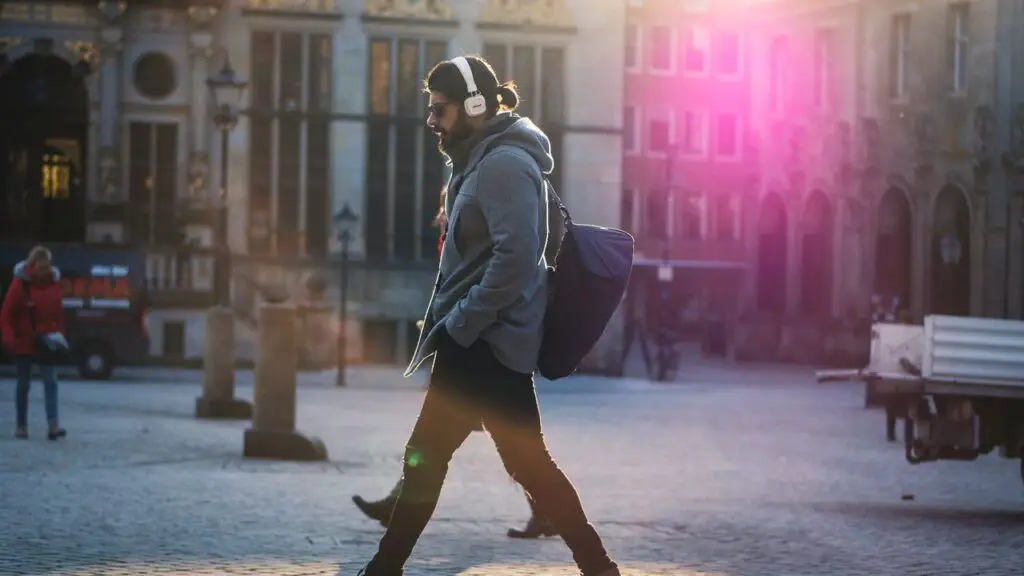man walking outdoor with headphones on