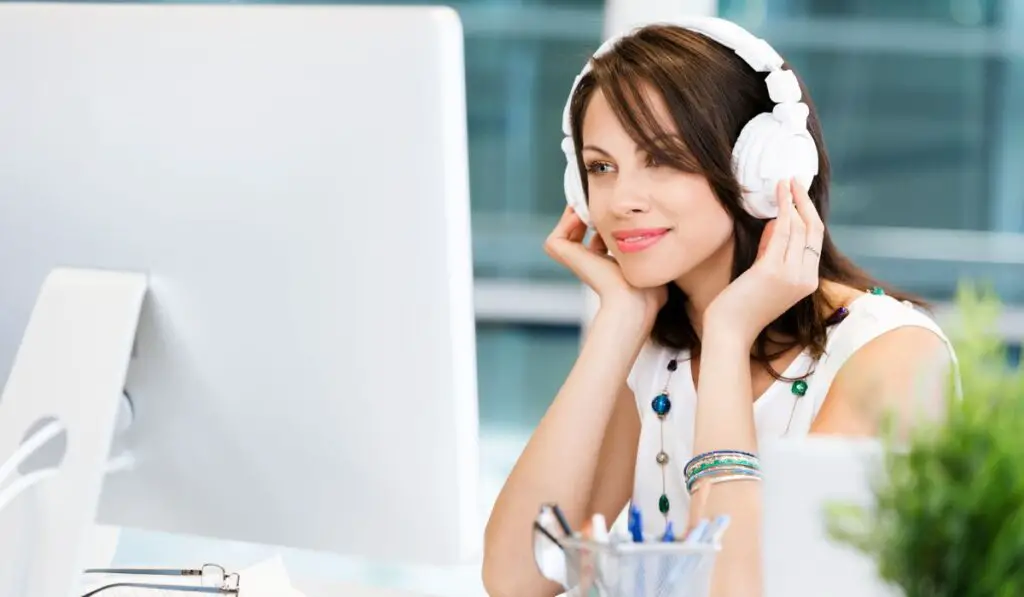 women wearing headphones at workplace
