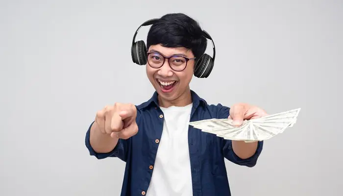 An image of a person giving money and taking headphones