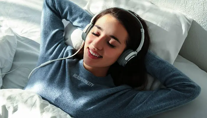 PERSON SLEEPING PEACEFULLY WITH EARBUDS